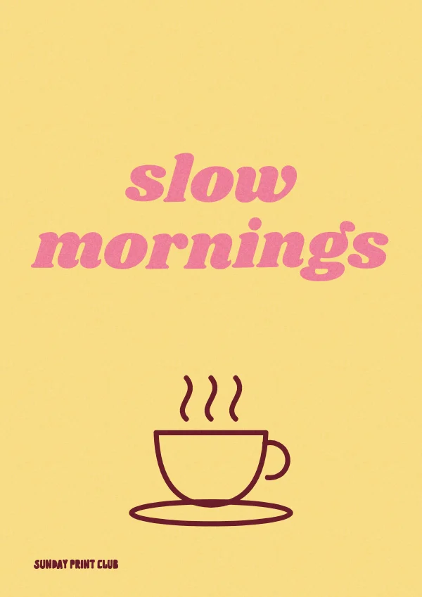 Slow Mornings print: pink script lettering above a line-drawn steaming coffee cup on butter yellow