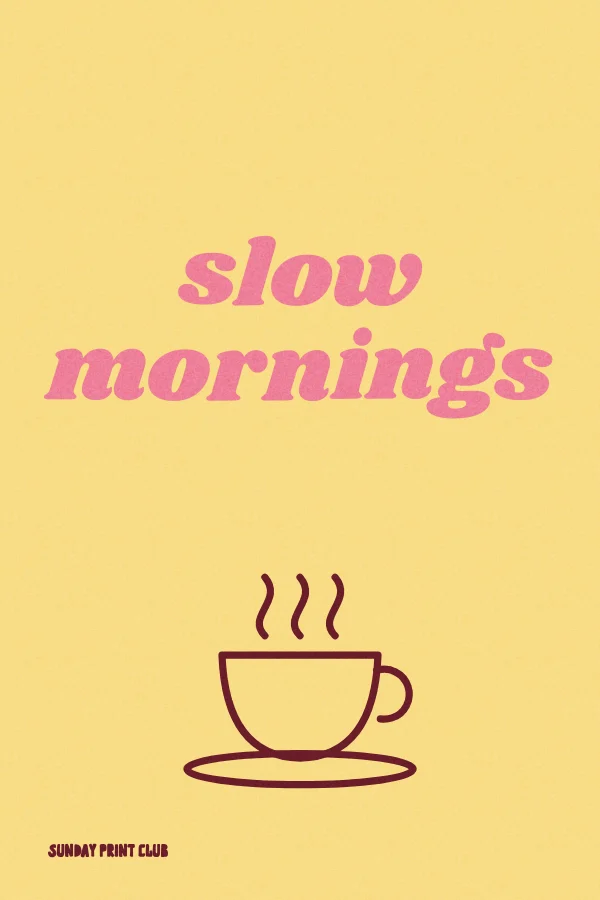 Slow Mornings print: pink script lettering above a line-drawn steaming coffee cup on butter yellow
